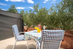 a table and two chairs sitting on a patio at Villa Fio - Rooms & Studio in Hvar