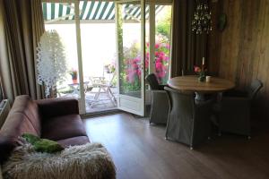 a living room with a couch and a table at Holiday home Landelijk Amsterdam in Amsterdam