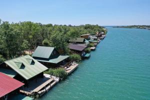 a row of houses on a dock in the water at Filipa River House Ada Bojana in Ulcinj +12 photos