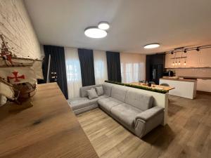 a living room with a couch and a kitchen at Family House FreeДом in Sinemorets