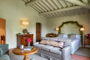 VIESCA Suites & Villas Il Borro Toscana في ريغلو: غرفة معيشة مع أريكة وسرير