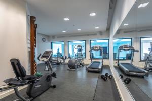 a gym with several treadmills and elliptical machines at Hotel Dom Goncalo & Spa in Fátima