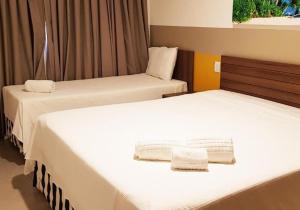 En eller flere senge i et værelse på OLIMPIA PARK RESORTs "MELHOR PREÇO "