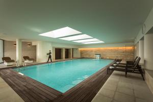 a pool with a person standing in the middle of it at Hotel Dom Goncalo & Spa in Fátima