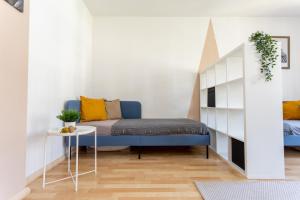 a living room with a blue couch and a table at FULL HOUSE Studios - Apartment Namibia in Chemnitz