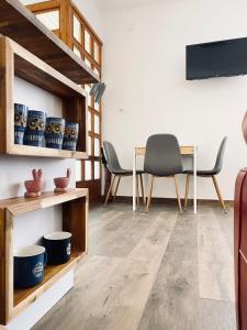 a living room with wooden floors and a table and chairs at Esther's Studio Keszthely in Keszthely