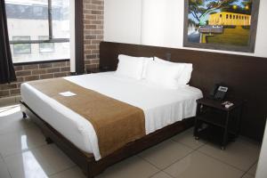 Ένα ή περισσότερα κρεβάτια σε δωμάτιο στο Hotel Acqua Medellín