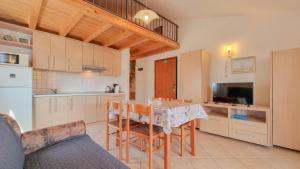 a kitchen with a table and some chairs in a room at Carlo in Lovrečica