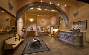 a large lobby with an archway and a living room at Hotel Italia Cortona in Cortona