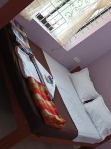 a bunk bed in a room with a skylight at Hakuna Matata Holiday Homes Goa Entire Apartment 1BHK in Baga