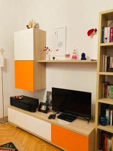 Zimmer mit einem Schreibtisch, einem TV und einem Bücherregal in der Unterkunft In the center & nice & quiet in Pula