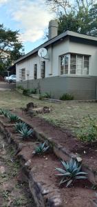 a house with a clock on the side of it at Thully Teams in Nelspruit