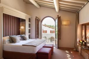 a bedroom with a bed and a large window at VIESCA Suites & Villas Il Borro Toscana in Reggello