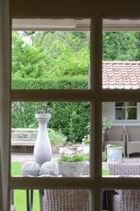 a window with a vase sitting on a table at bb-jonashome in Venlo
