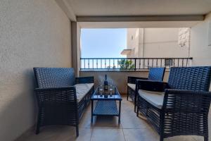 a balcony with chairs and a table and a window at Porta Volta Residence in Becici