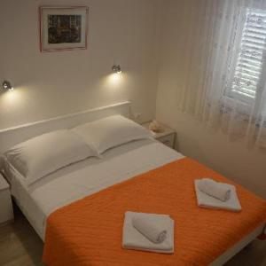 Postel nebo postele na pokoji v ubytování Apartments Leon