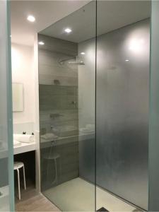 a glass shower in a bathroom with a sink at Giupy Home in Catania