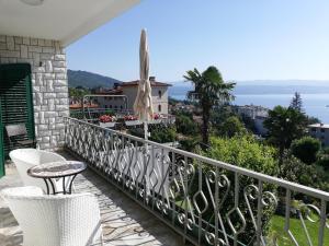 a balcony with a table and chairs and the ocean at Villa Allegra in Lovran
