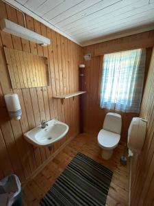 a small bathroom with a sink and a toilet at Lofoten Å HI hostel in Å