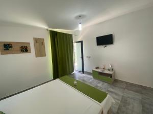 a bedroom with a bed and a television in it at Vara la Corbu in Corbu