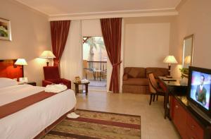 A bed or beds in a room at Rehana Royal Beach Resort - Aquapark & Spa - Family & Couples Only - Premium Ultra All-Inclusive 24H