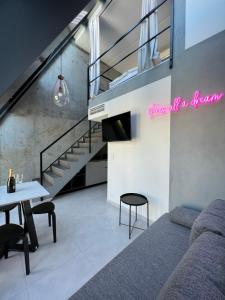 a living room with a couch and a table at NEON APARTMENTS in Sopot