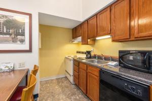 a kitchen with a sink and a microwave at Residences at Daniel Webster in Merrimack