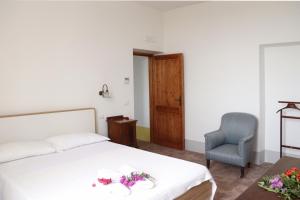 a bedroom with a bed and a chair and a table at Agriturismo Morani in Santa Severa