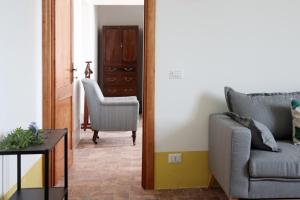a living room with a couch and a chair at Agriturismo Morani in Santa Severa
