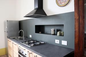 a kitchen with a sink and a stove top oven at Agriturismo Morani in Santa Severa