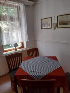 a dining room with a table and a window at Lucerna in Hřensko