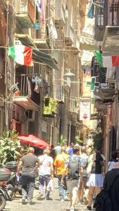 a group of people walking down a city street at Casa Gio’ in Naples