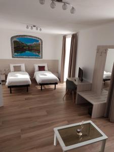 a hotel room with two beds and a table at B&B ANGELA Valdinon in Predaia