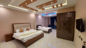 a hotel room with two beds and a television at City Seasons Hotel Murree in Murree