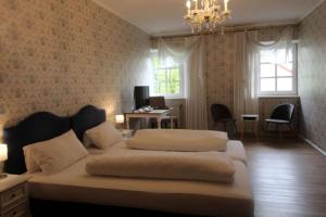 1 Schlafzimmer mit 2 Betten, einem Schreibtisch und Fenstern in der Unterkunft Hotel-Gasthof Opel in Heinersreuth