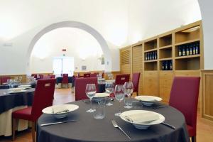 a dining room with a table with wine glasses at Relais Villa Buonanno in Cercola