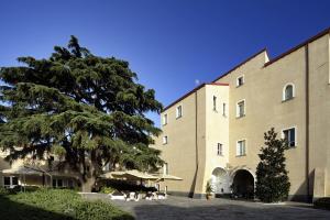 a large building with a tree in front of it at Relais Villa Buonanno in Cercola
