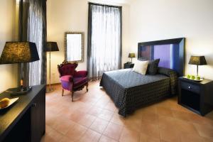 a hotel room with a bed and a television at Relais Villa Buonanno in Cercola