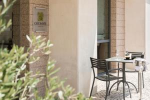 a table and chairs sitting outside of a restaurant at Hotel Dom Goncalo & Spa in Fátima