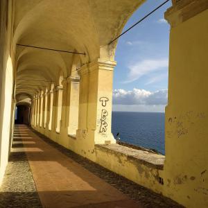 an old building with a view of the ocean at La casa rosa in Lingueglietta