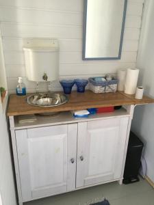 a bathroom counter with a sink and a mirror at Savikulma savihuone B&B in Mynämäki +30 photos