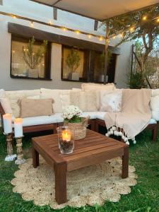 a living room with couches and a table and candles at Hotel Boutique Valle de Oca in Villanasur-Río de Oca