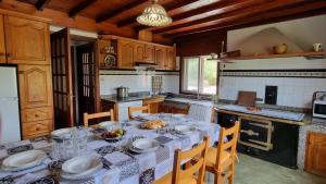 a kitchen with a table with plates of food on it at Finca Bouzas in Teo