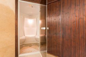 a shower with a glass door in a bathroom at Hotel Dom Goncalo & Spa in Fátima