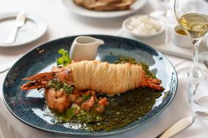 a plate of food with shrimp on a table at Hotel Dom Goncalo & Spa in Fátima