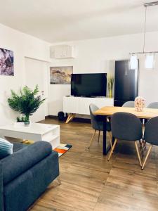 a living room with a table and a tv at Apartments Stara Baska in Stara Baška