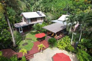 an aerial view of a house with a red umbrella at Salt Lake Lodge in Savusavu