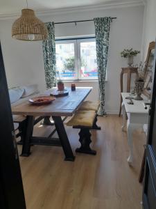 a living room with a wooden table and a dining room table at Villa Alegria in Ericeira