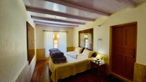 a bedroom with a large bed in a room at Lahaul Home Stay Sumnam in Tāndi