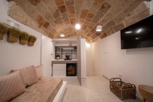 a living room with a couch and a stone ceiling at New Dimora Valmar in Polignano a Mare